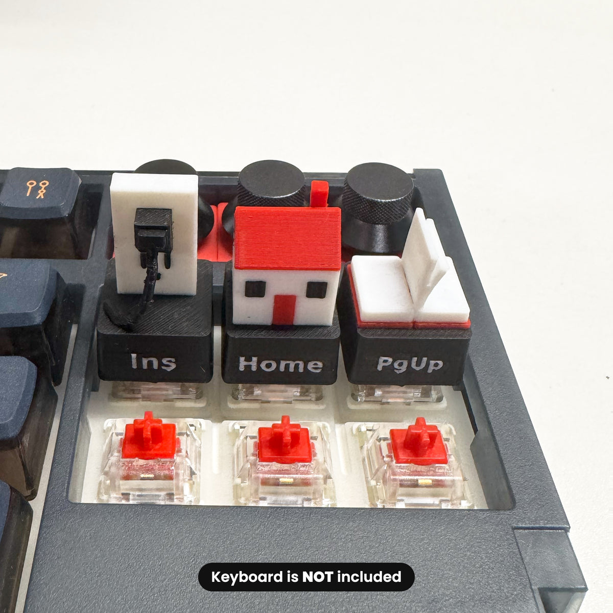 Insert, Home and Page Up keycaps installed, with MX-style switches below
